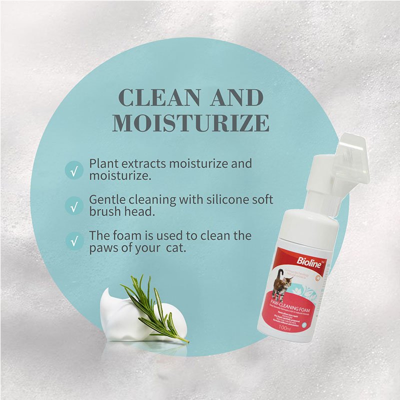 This advertisement image showcases the Bioline Paw-Cleaning Foam bottle next to foam and a sprig of rosemary, emphasizing its dual benefits under the heading "CLEAN AND MOISTURIZE." The text claims the product uses plant extracts to moisturize, provides gentle cleaning with its silicone soft brush head, and the foam is specifically formulated for cleaning the paws of cats.