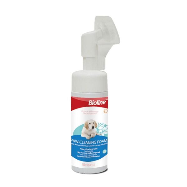 This image shows the Bioline Paw-Cleaning Foam bottle (150 ml) against a white background. The white pump bottle features a red and blue label that highlights "German technology, Natural extracts" and contains a dry foam formula rich in natural minerals, designed to be rapid-acting and non-stimulating. A white silicone soft brush applicator is integrated into the top of the bottle.