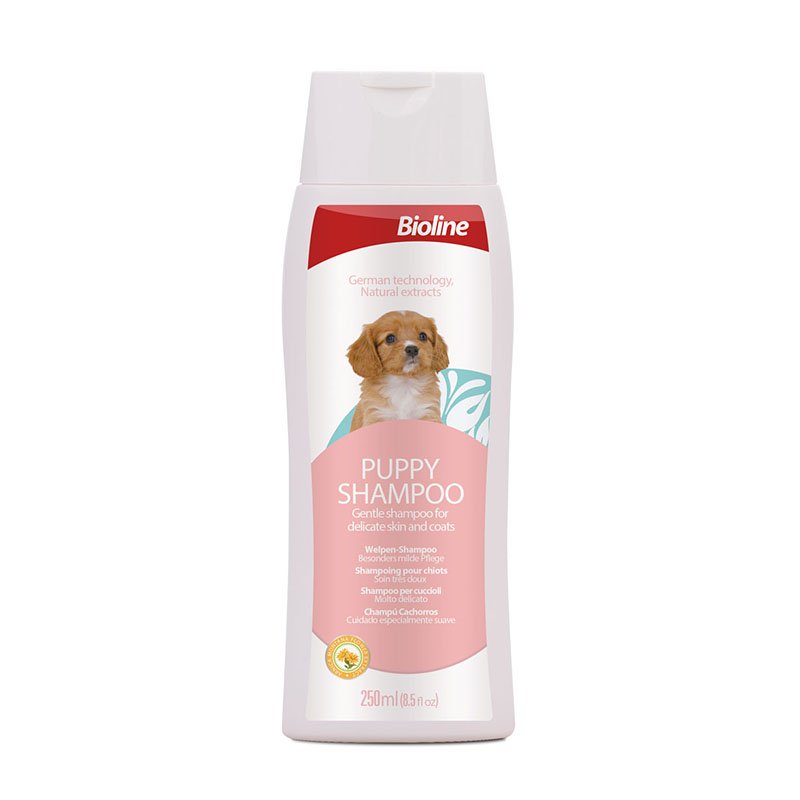 White plastic bottle of Bioline Puppy Shampoo, 250ml size, a gentle shampoo for delicate skin and coats, featuring an image of a small brown and white puppy on the label.