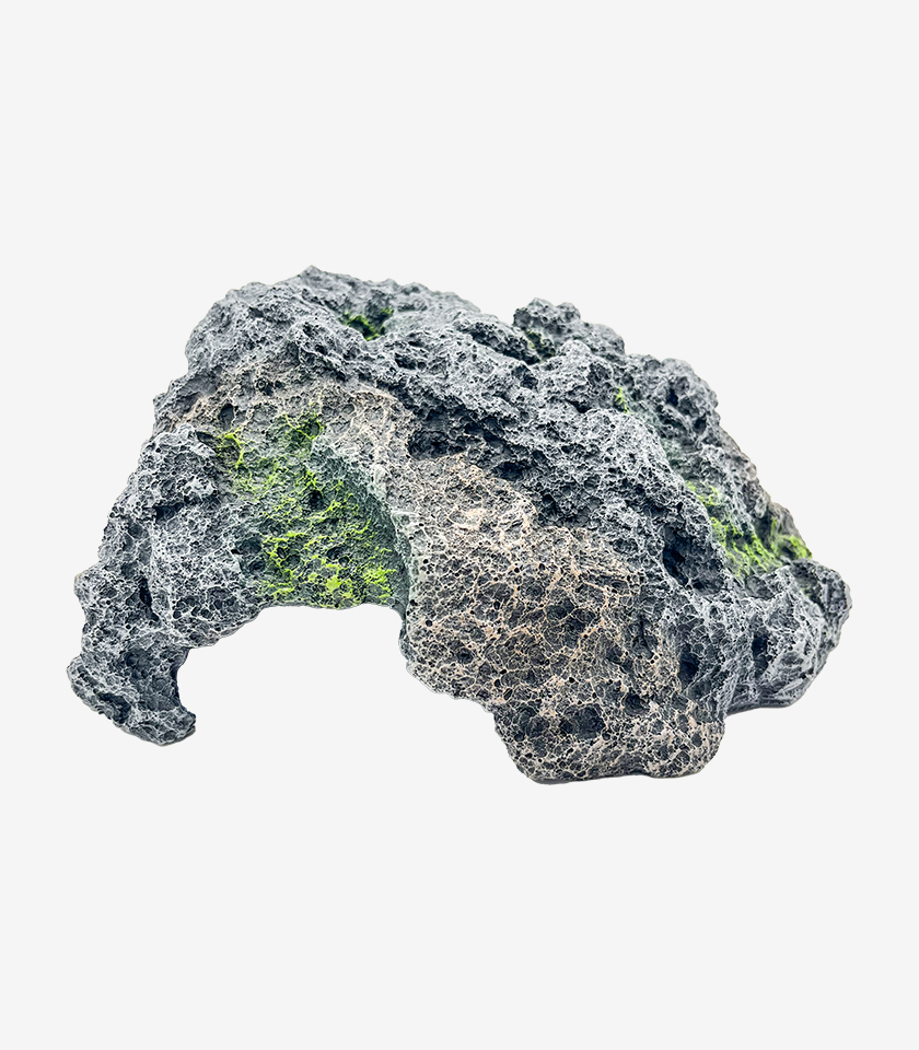 Sea Stone Hideout aquarium decoration, a dark gray oceanic stone with a porous, pitted texture and green moss accents.