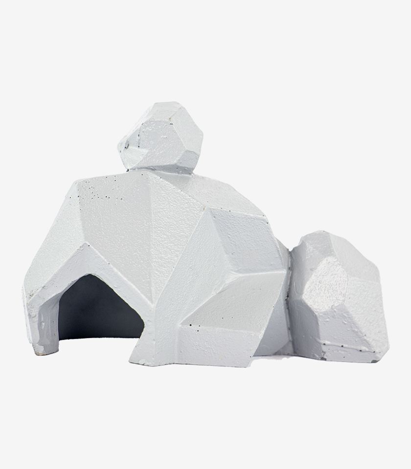Animated Rock Stack aquarium ornament, a white geometric sculpture of an animal with a faceted texture and a cave underneath.