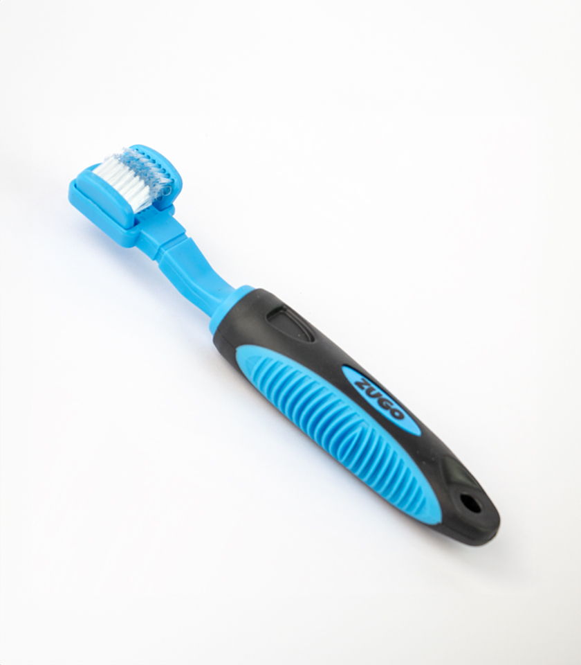 Dog Tooth Brush, a blue and black three-sided toothbrush with a blue handle that has a black textured grip and the word ZUGO in blue letters.