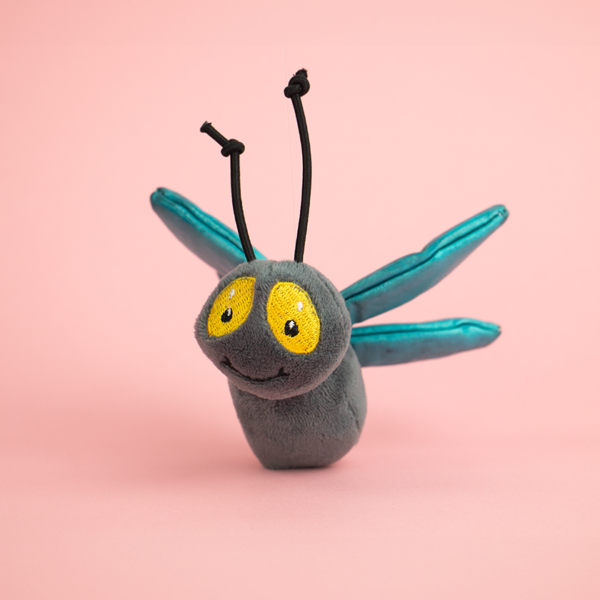 Zugo Fly Plush Catnip & Sound Toy, a plush toy shaped like a fly that is dark gray with light blue wings, large yellow eyes, and black string antennae.