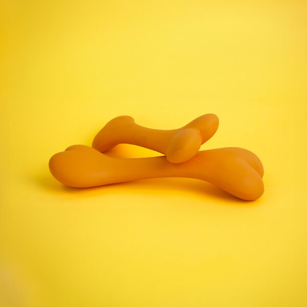 Bone+ Rubber Dog Toy, a pair of orange, stylized bone-shaped toys with a smooth, curved design.
