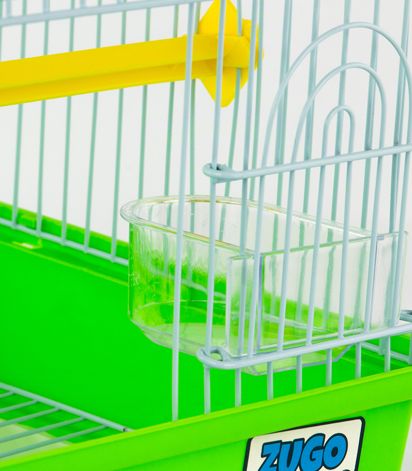 Zugo Seed Feeder Inside Cup, a clear plastic seed feeder cup attached to the white wire side of a bird cage with a green base and a yellow perch inside.