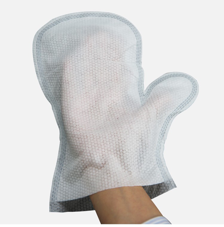 My Turf Pet Cleaning Glove on a Hand, a white, textured, mitten-shaped cleaning glove made of non-woven fabric being worn on a hand, ready for gentle pet grooming.