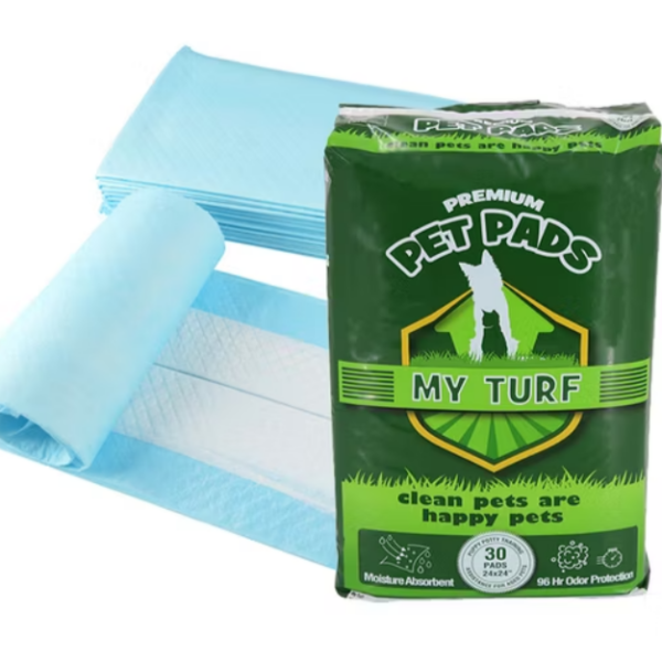 My Turf Premium Pet Pads and Unrolled Pad, a stack of blue and white puppy training pads unrolled and lying behind a green retail bag of MY TURF PREMIUM PET PADS, highlighting the Moisture Absorbent and 96 Hr Odor Protection features.