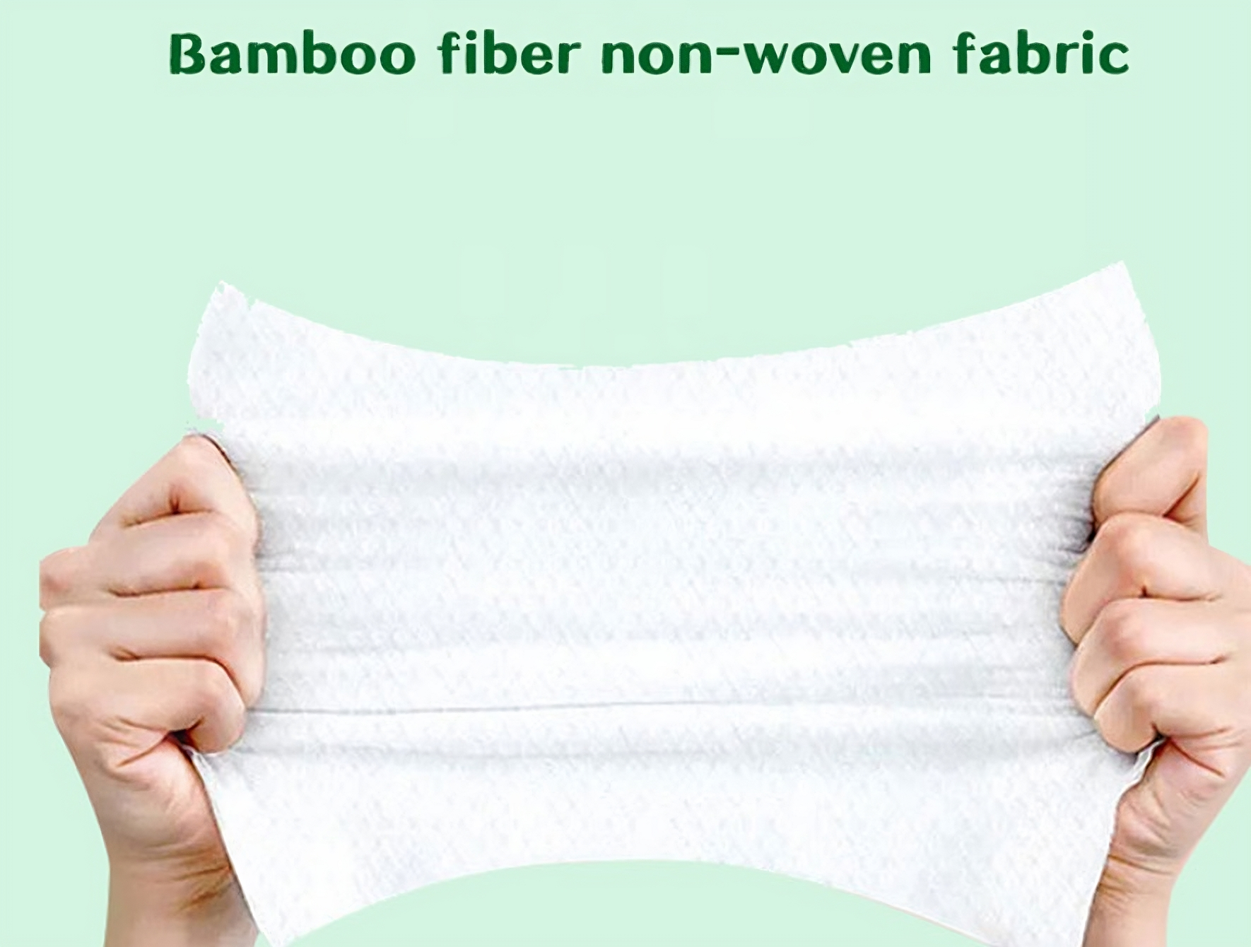 Bamboo Fiber Non-Woven Fabric Wipes, a pair of hands gently stretching a piece of soft, white, non-woven fabric, with the text "Bamboo fiber non-woven fabric" centered above the image.