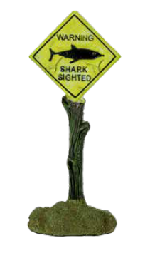 Shark Warning Sign Aquarium Decoration. A resin ornament resembling a yellow diamond-shaped sign on a dark, mossy post with the text 'WARNING SHARK SIGHTED' and a black shark silhouette.