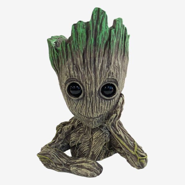 Groot aquarium ornament, a figurine of the Baby Groot character with a wood-like texture and green moss on its head.