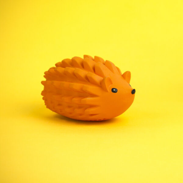 Zuhog Rubber Dog Toy, an orange toy shaped like a hedgehog with a spiky texture on its back.