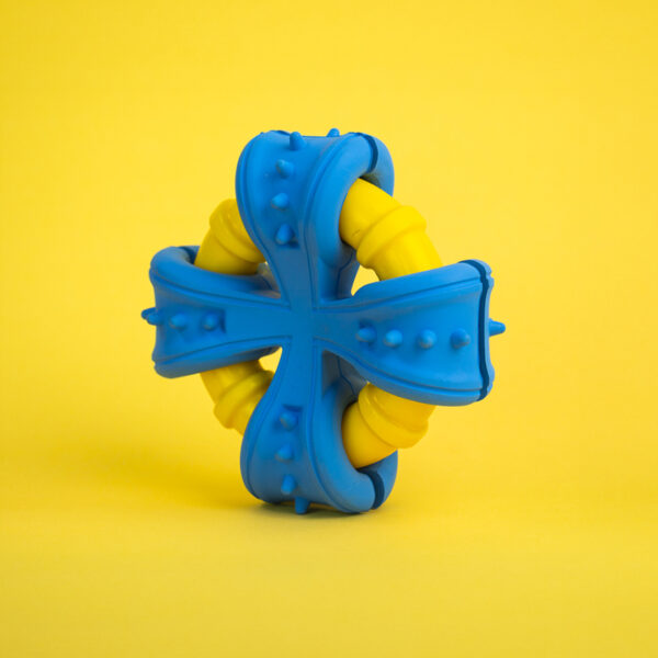 Biteblast Rubber Dog Toy, a blue, cross-shaped toy with yellow ribbed pieces in the center.