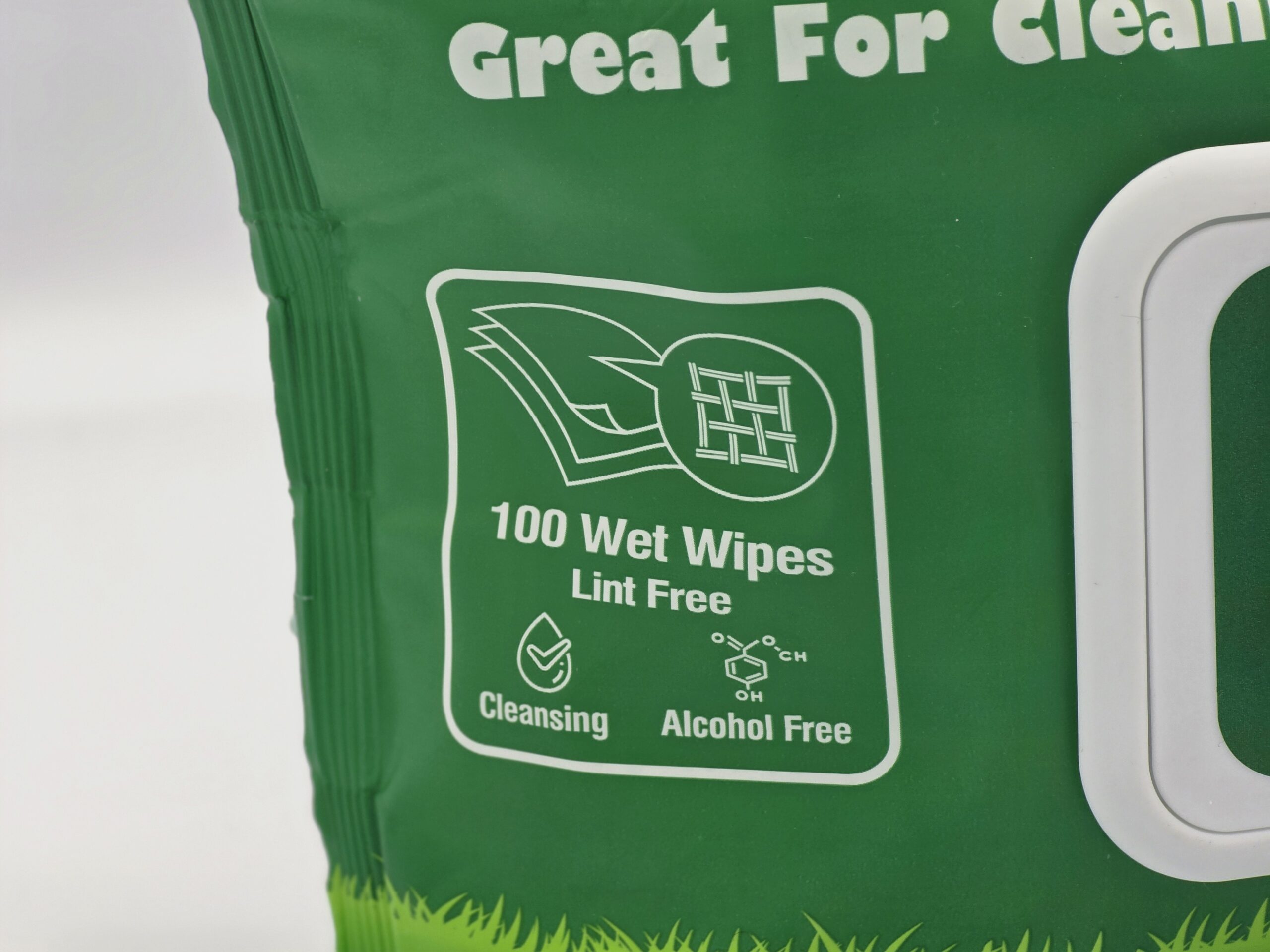 My Turf Pet Wipes Features Close-up, a macro view of the bright green retail packaging highlighting the claims 100 Wet Wipes, Lint Free, Cleansing, and Alcohol Free with a chemical structure symbol.