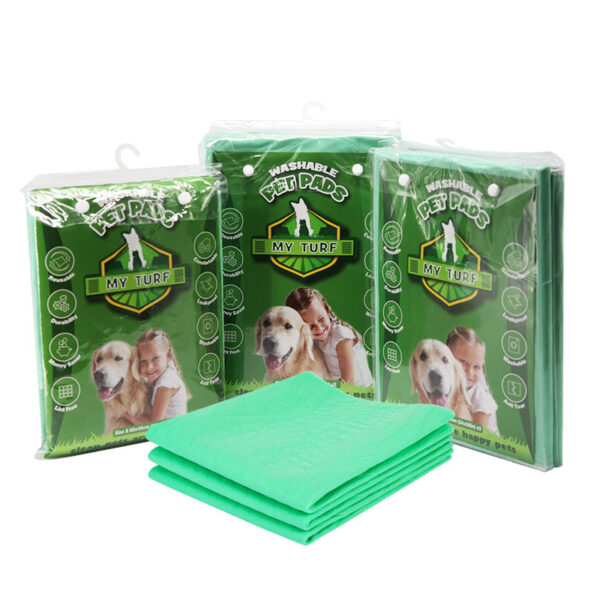 My Turf Reusable Washable Pet Pads (Green Packaging), three green retail bags of WASHABLE PET PADS stacked behind four folded green quilted pads, featuring images of a golden retriever and a child.