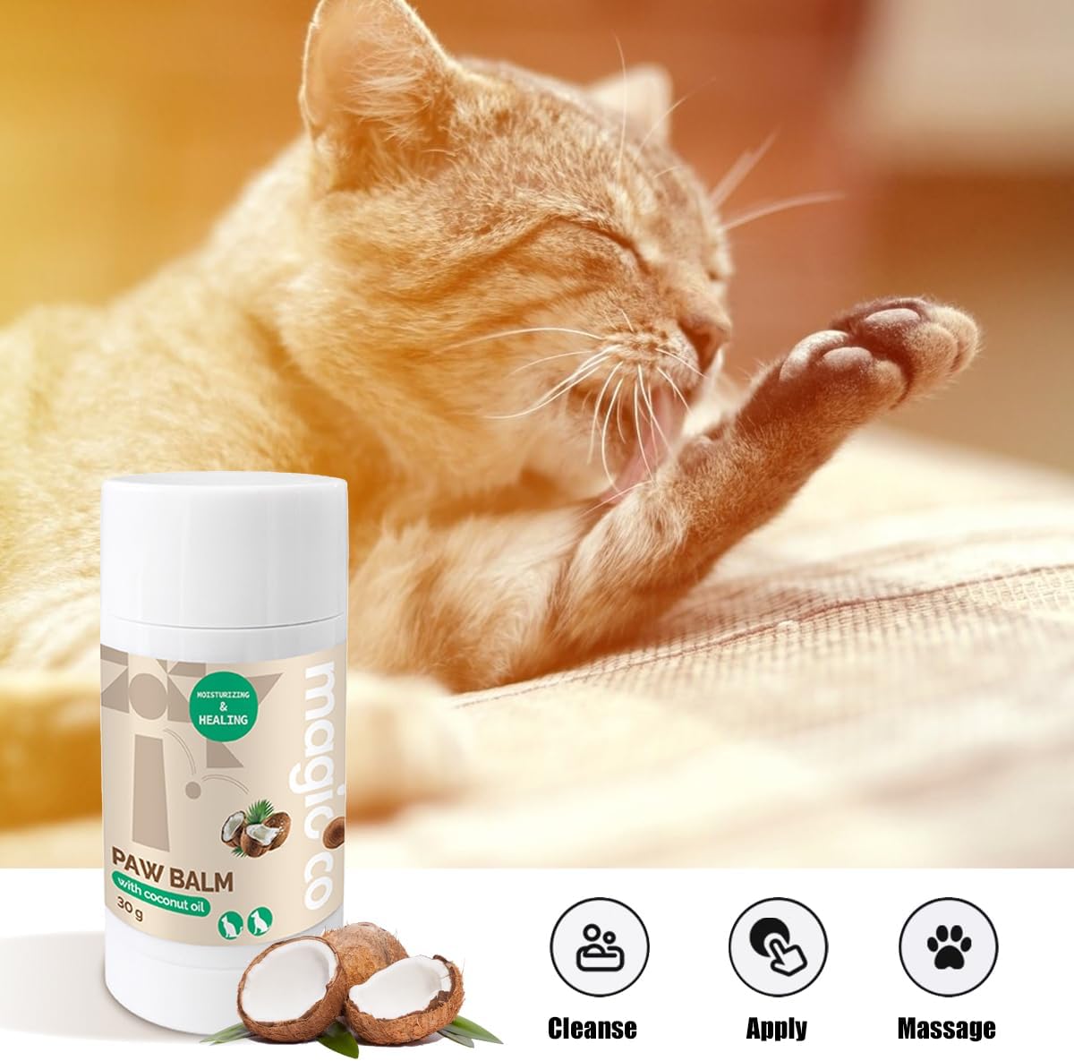 This image features the Magicoco Paw Balm with Coconut Oil stick in the foreground, with an orange tabby cat in the background licking its paw. Text on the image provides three clear application icons and keywords: Cleanse, Apply, and Massage. The balm is labeled as "MOISTURIZING & HEALING" and is for dogs and cats.